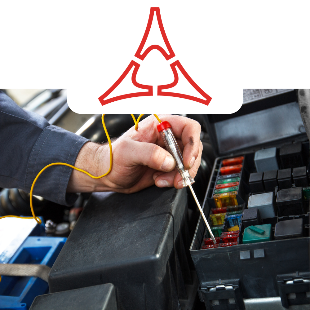 Person working on a car's fuse box with a Dodge logo above