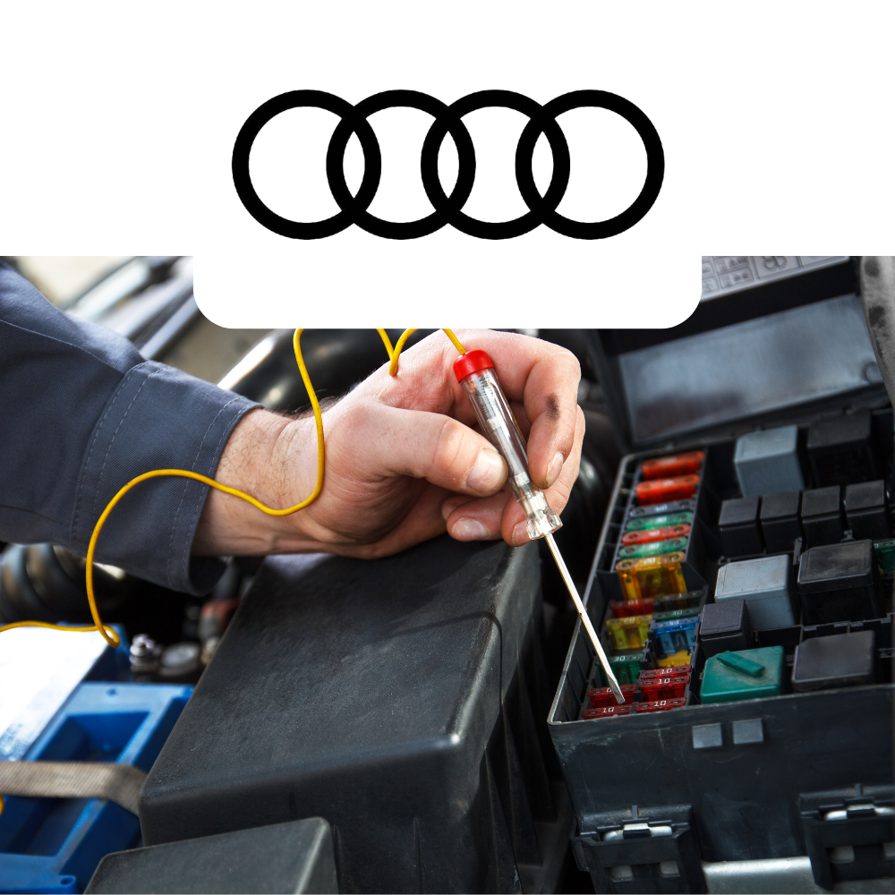 Person working on a car's fuse box with Audi logo above