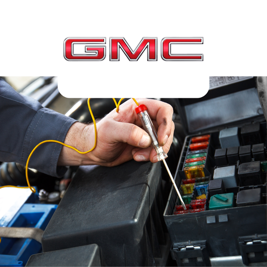 Person working on a car's fuse box with GMC logo above